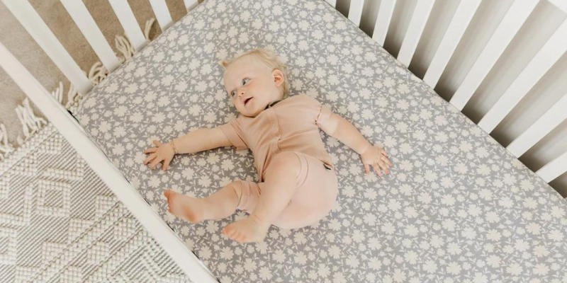 Smiling baby girl in crib