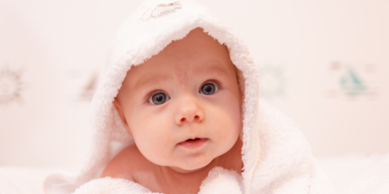 Baby covered in a bath towel