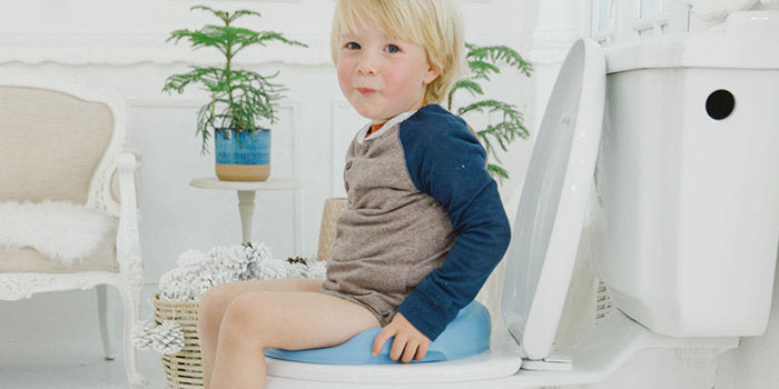 Toddler sitting on toilet