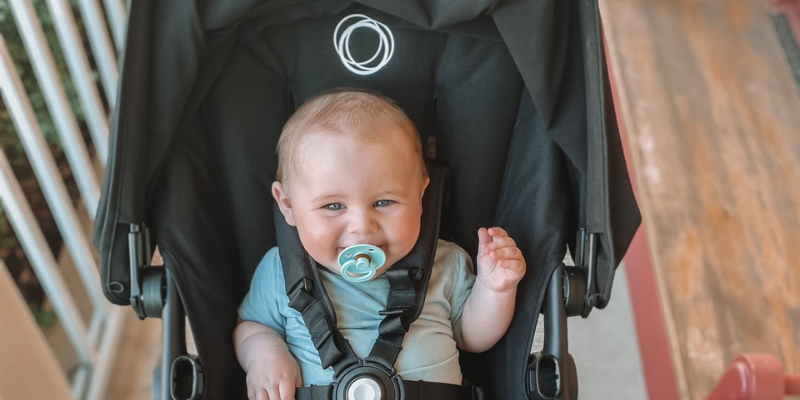 Baby smiling in a Bugaboo Stroller