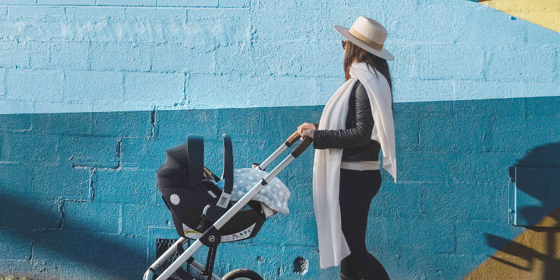Women pushing baby in stroller with Cybex Aton 2 attached