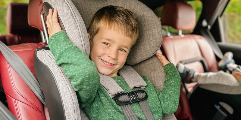 Little Boy Sitting in Foonf Convertible Car Seat