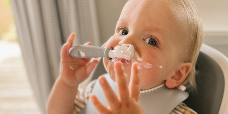 Kids holding  BabyBjorn spoons eating out of Baby Bjorn bowl