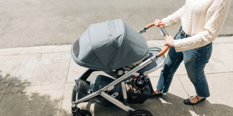 Mom pushing UPPAbaby Vista V3 Stroller on sidewalk