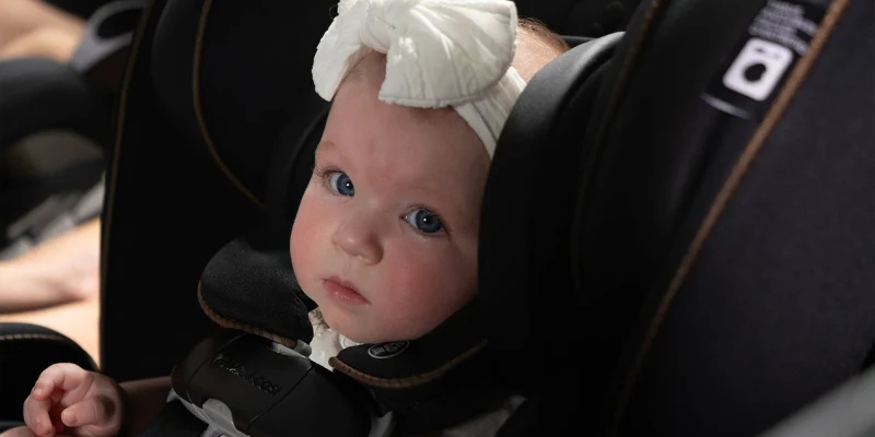 Baby sitting in the Maxi-Cosi Kani all-in-one car seat