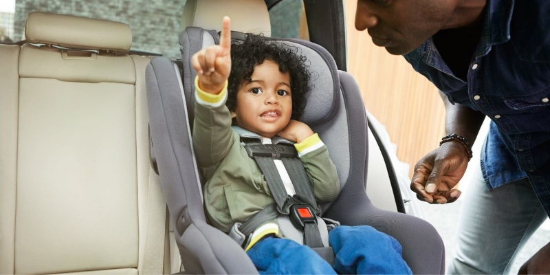 Little boy pointing while sitting in his Nuna RAVA Convertible Seat