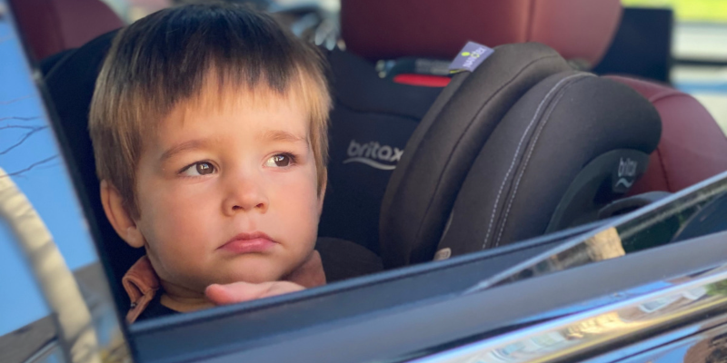 Little boy looking out the car window sitting in a Britax One4Life ClickTight Convertible Seat