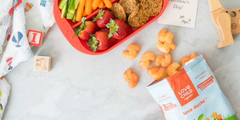 Love Child Puff Snacks on Table With Food 