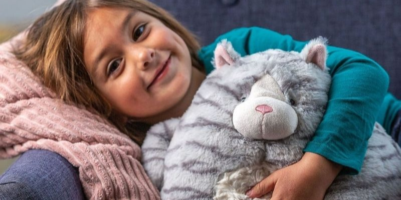 Little Girl Lying Down Holding Plush Toy