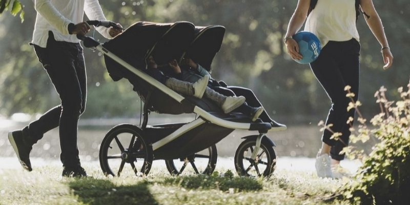 image of mom walking in the park with the Thule Urban Glide 2 Double Stroller