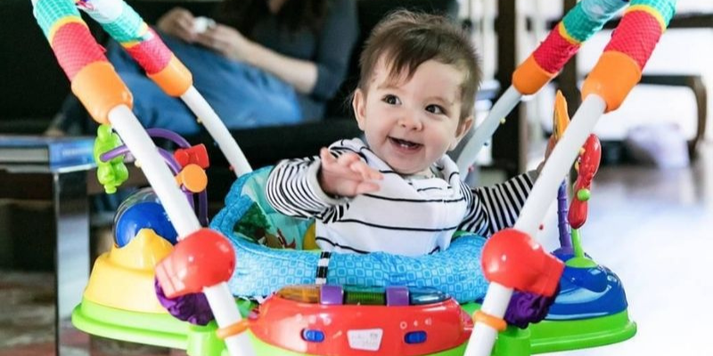 Baby Smiling While Sitting In Activity Jumper
