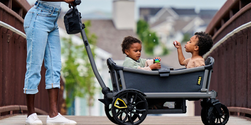 Woman Pushing Veer Cruiser City 2-Seater With Two Little Boys Sitting Inside