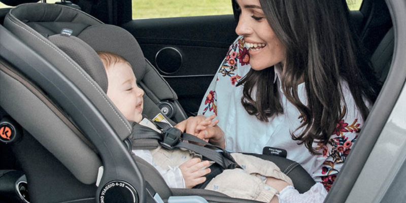 Mom bucking baby in Peg Perego infant seat