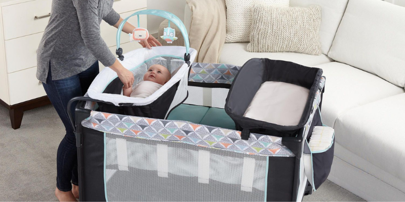 Woman Looking at Baby Lying in Bassinet in Ingenuity Smart & Simple Playard