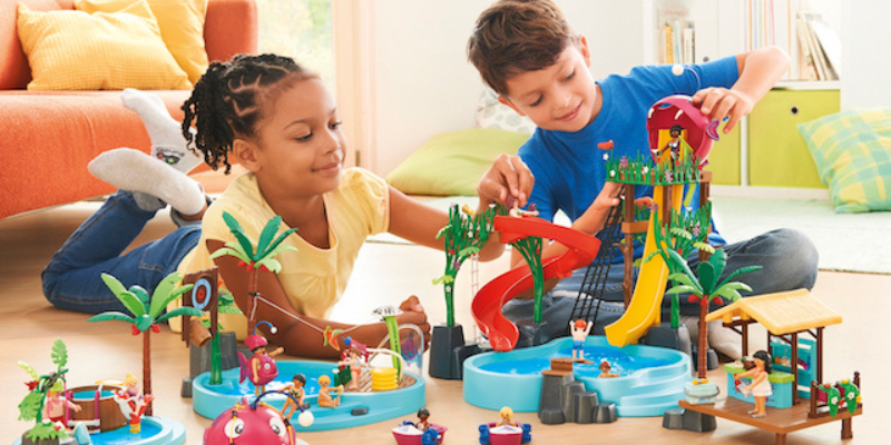 Little Girl and Little Boy Sitting on the Floor Playing with Playmobil Toys