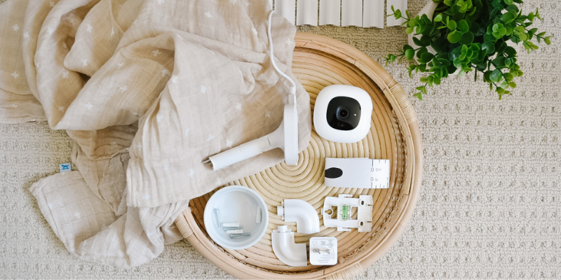 Nanit Pro Complete baby video monitor on Table With Blanket
