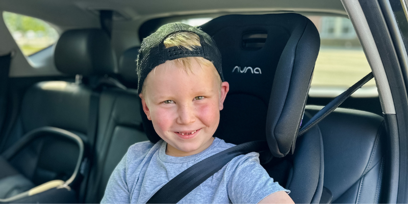 Boy Sitting in Nuna ROYL Harnessed Booster Car Seat