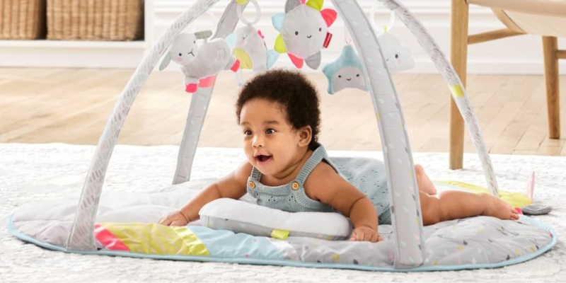 Baby Lying on Silver Lining Cloud Activity Gym by Skip Hop