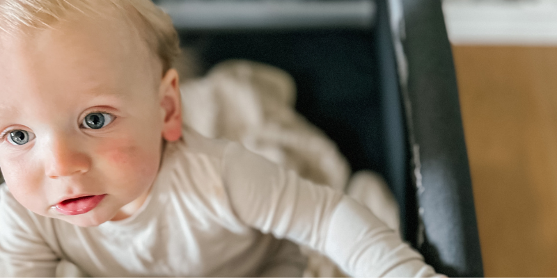 Baby in Silver Cross Slumber Playard