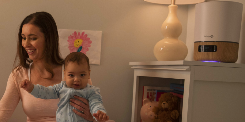 Mom playing with baby near safety 1rst smart soother