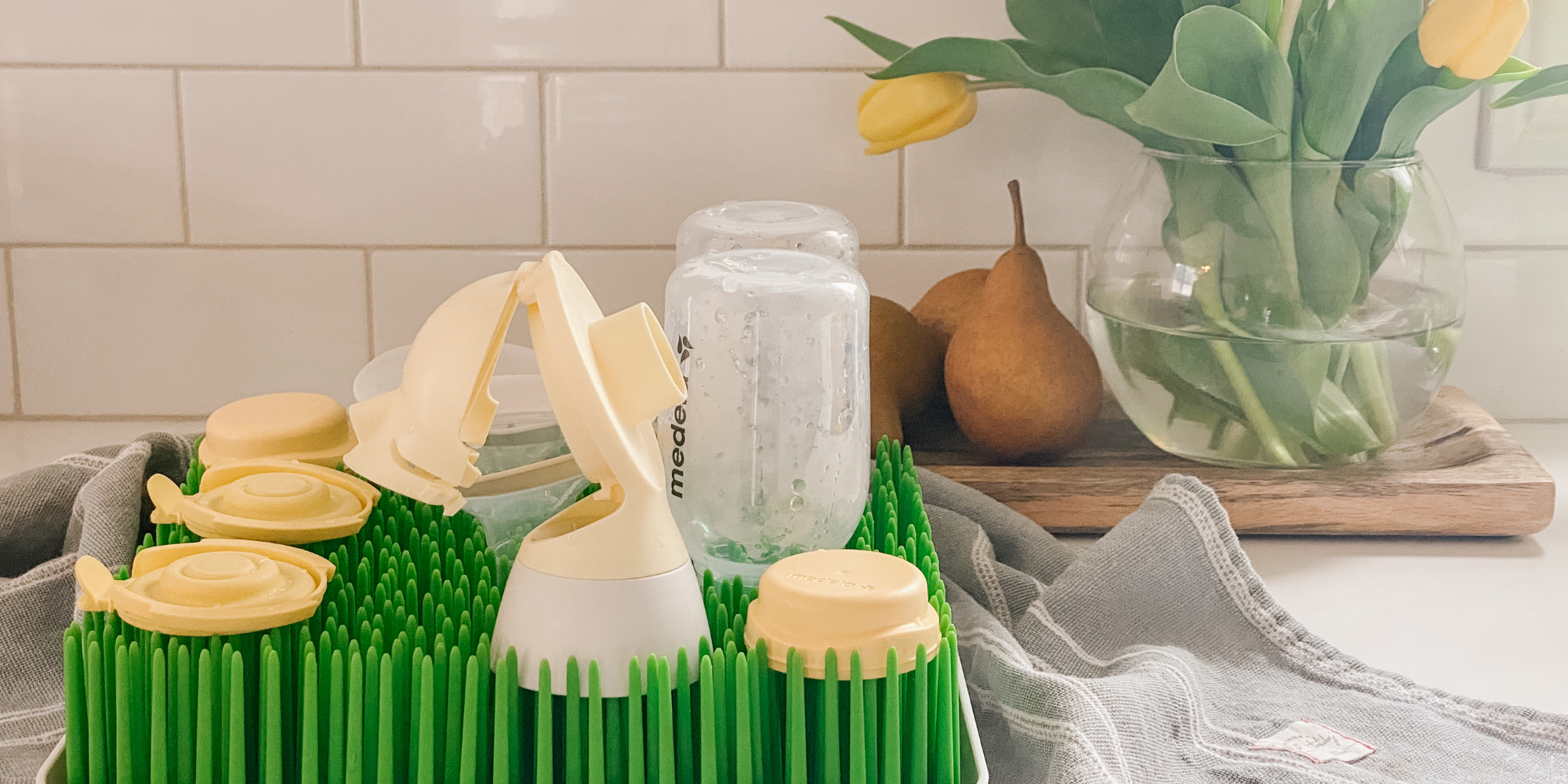 Medela products drying on a green drying rack on a kitchen counter