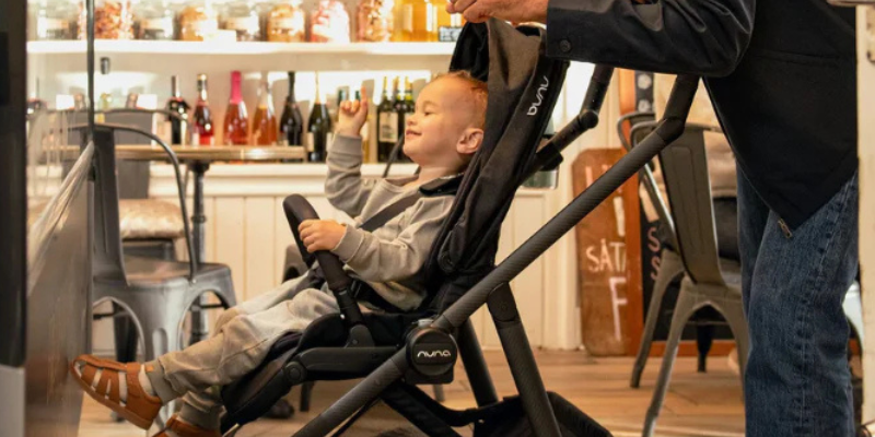 Toddler in Nuna SWIV Stroller in shop