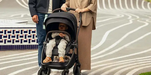 Parents pushing Nuna SWIV stroller