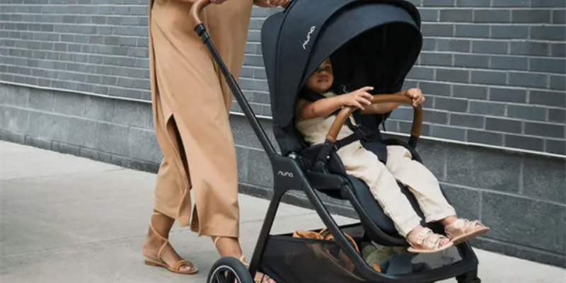 Mom pushing toddler in Nuna TRIV Next stroller