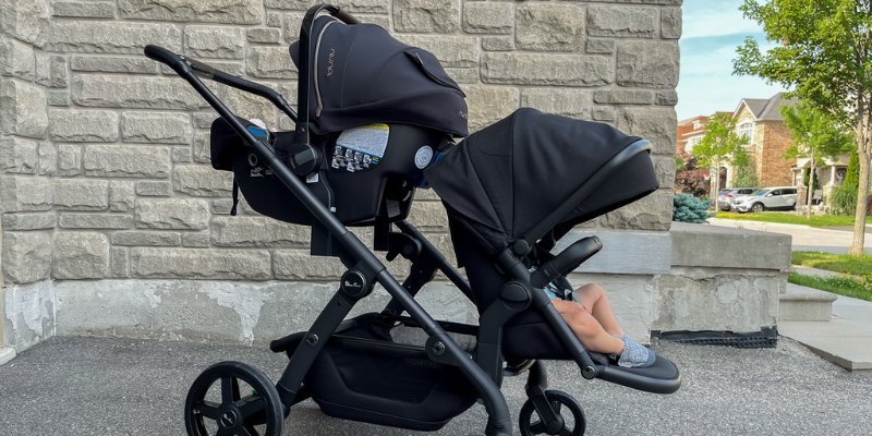 Two little boys sitting in silver cross wave stroller