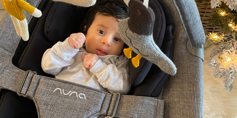 Baby sitting in a Nuna LEAF Swing