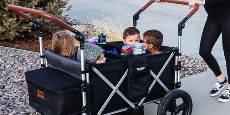 Mom pushing 4 kids in the Keenz 7S+ 4 Passenger Stroller Wagon