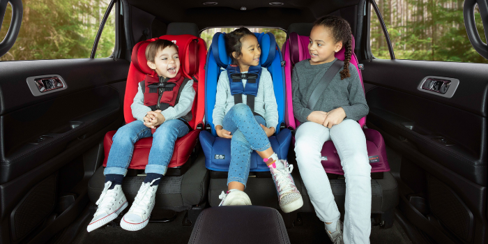 Three kids sitting in differently coloured Diono Car Seats