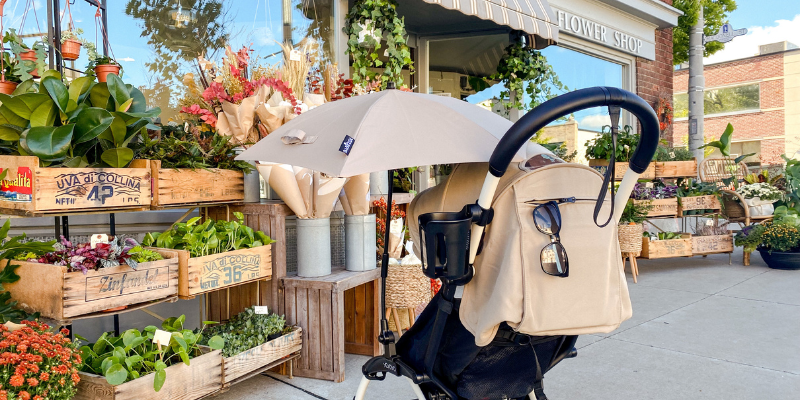 Stokke YOYO2 Stroller parked by outdoor flower stall