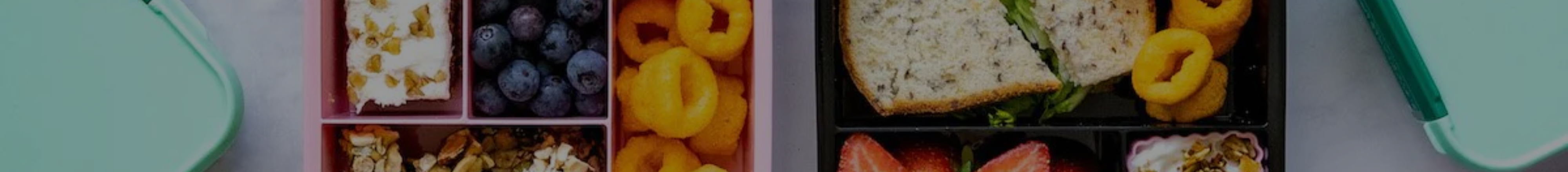Close-up of food stored in the compartments of Little Lunch Box Co bento boxes