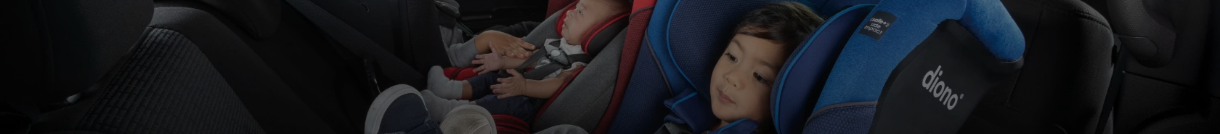 Two children sitting in their Diono convertible seats rear-facing