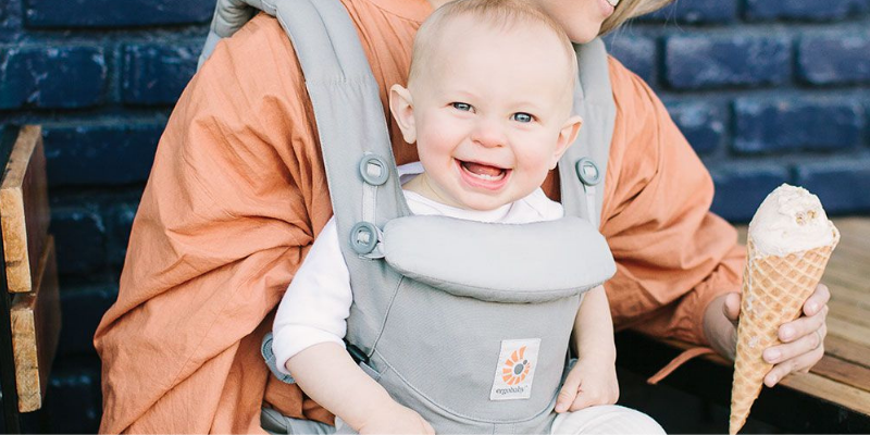 Baby Smiling While Sitting In ERGObaby 360 Omni Carrier