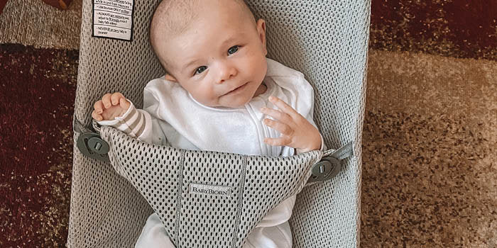 Baby smiling in a BabyBjorn bouncer bliss