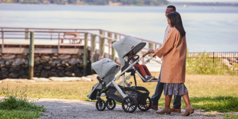 Family walking on a trail with UPPAbaby VISTA V2 in tandem mode
