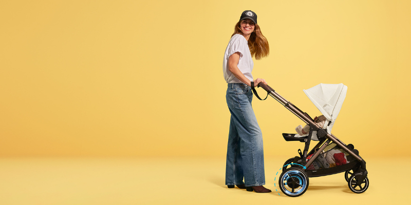 Woman in baseball hat pushing Cybex e-Gazelle S Stroller