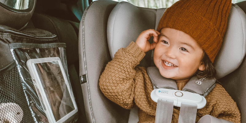 Todder in winter hat and sweater in Cybex Sirona S Convertible Car seat