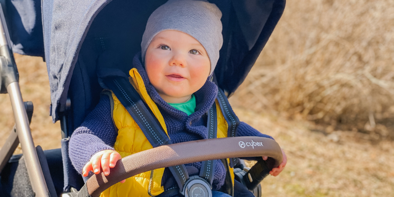 Little boy with a hat on sitting in the Cybex Gazelle S Stroller