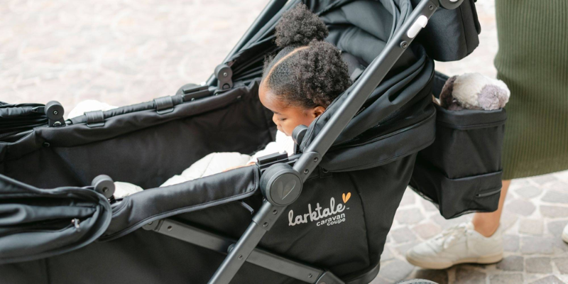 Baby girl sitting in a Larktale wagon