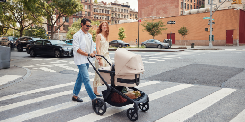  Mom and dad pushing Bugaboo Kangaroo stroller across a crosswalk