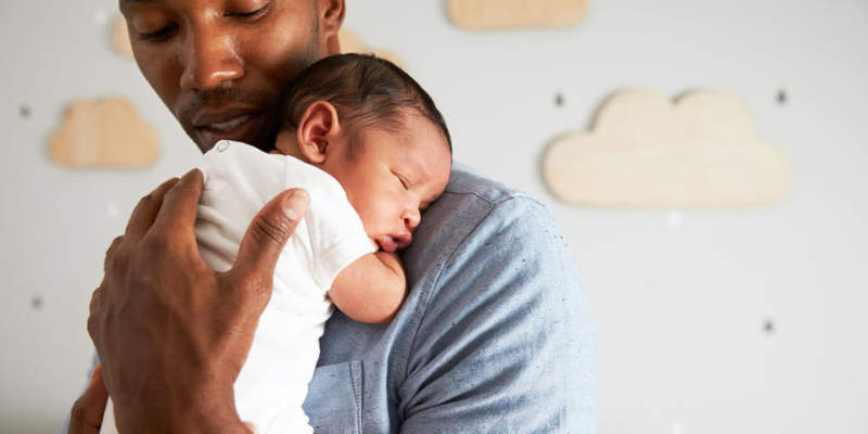 Dad holding newborn baby