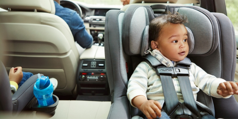 Little boy looking out the window sitting in his Nuna RAVA Convertible Seat