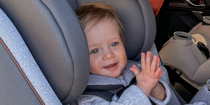 Child Sitting in All-In One Car Seat in Back Seat of Car