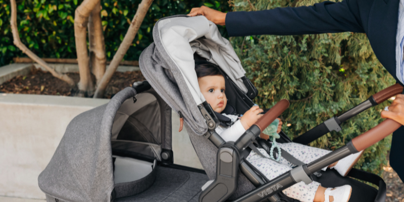 Women adjust canopy on UPPAbaby Vista V3 Stroller