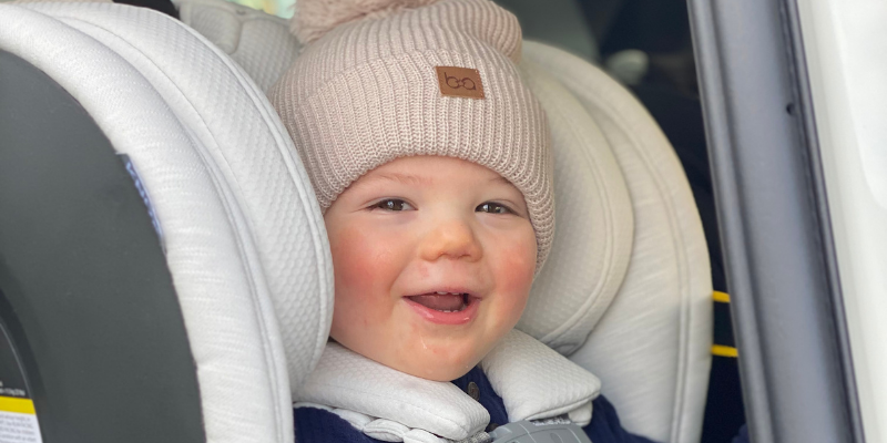 Baby smiling in the car sitting in an UPPAbaby KNOX Convertible Car Seat