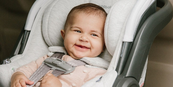 Baby smiling in infant car seat