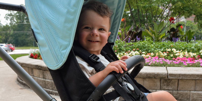 Little Boy Sitting in Bugaboo Dragonfly Stroller Close-Up